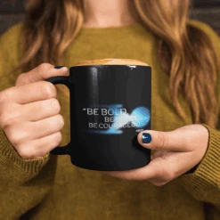 Star Trek: Discovery Be Bold. Be Brave. Be Courageous. Black 11 Oz Mug 9 Star Trek: Discovery Be Bold. Be Brave. Be Courageous. Black 11 Oz Mug -T-shirt Store mug mockup with hot chocolate held by a woman 11949a